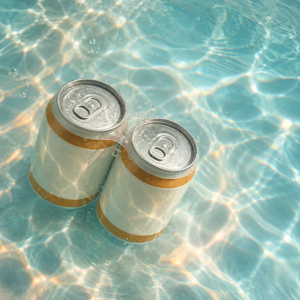 Two short, blank ivory-colored aluminum cans with amber bands and silver pull-tab tops are joined side by side by a clear carrier, floating diagonally in…