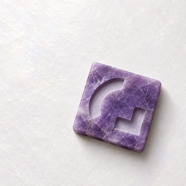 A rotated purple mineral square tile with a broad curved recess and a separate stepped channel rests on a softly textured pearl-white ground, casting a diffuse…