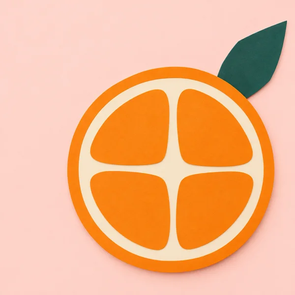 A large orange cross-section made of four orange segments and ivory channels sits against a pale blush background, with a dark teal leaf extending from its…