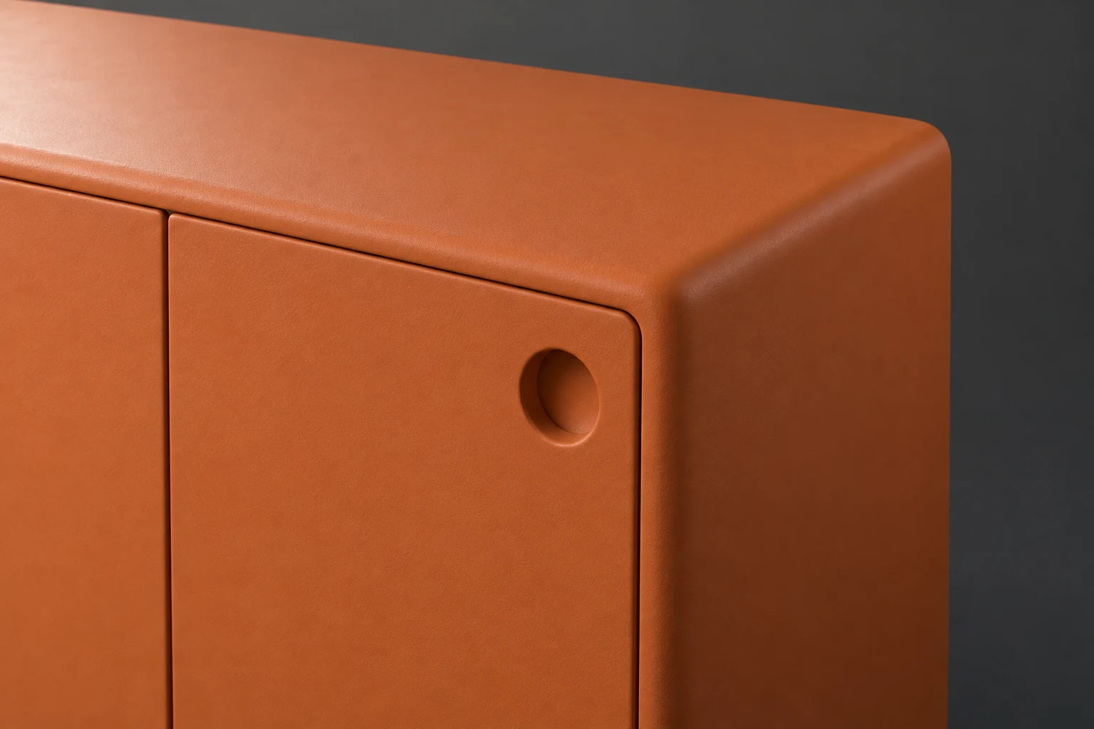 Close-up 3D render of a burnt-orange sideboard corner, showing its rounded top and side, two closed door panels, narrow seams and a circular recessed finger…