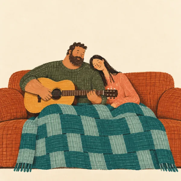 A bearded man and a long-haired woman sit close together on a wide rust-orange sofa, with the woman leaning on his shoulder.