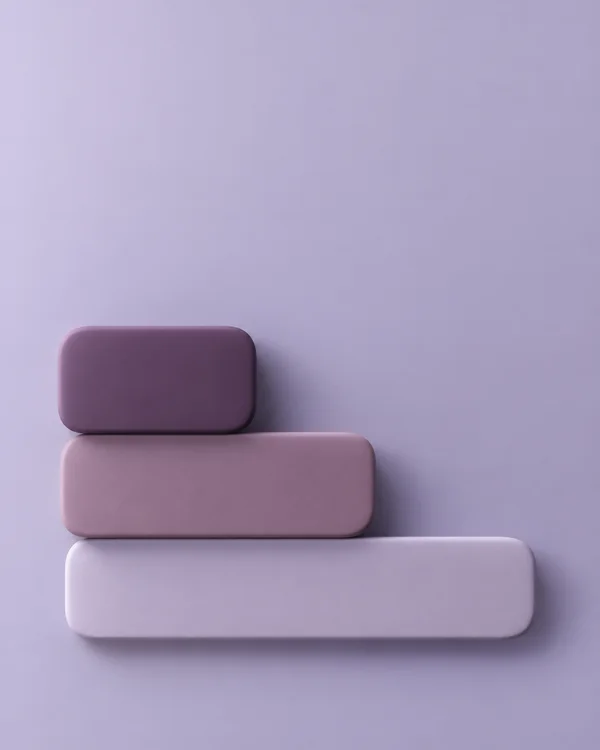 Three rounded rectangular mauve and lilac slabs form a stepped stack in the lower-left portion of a lavender background, with soft shadows and ample empty…