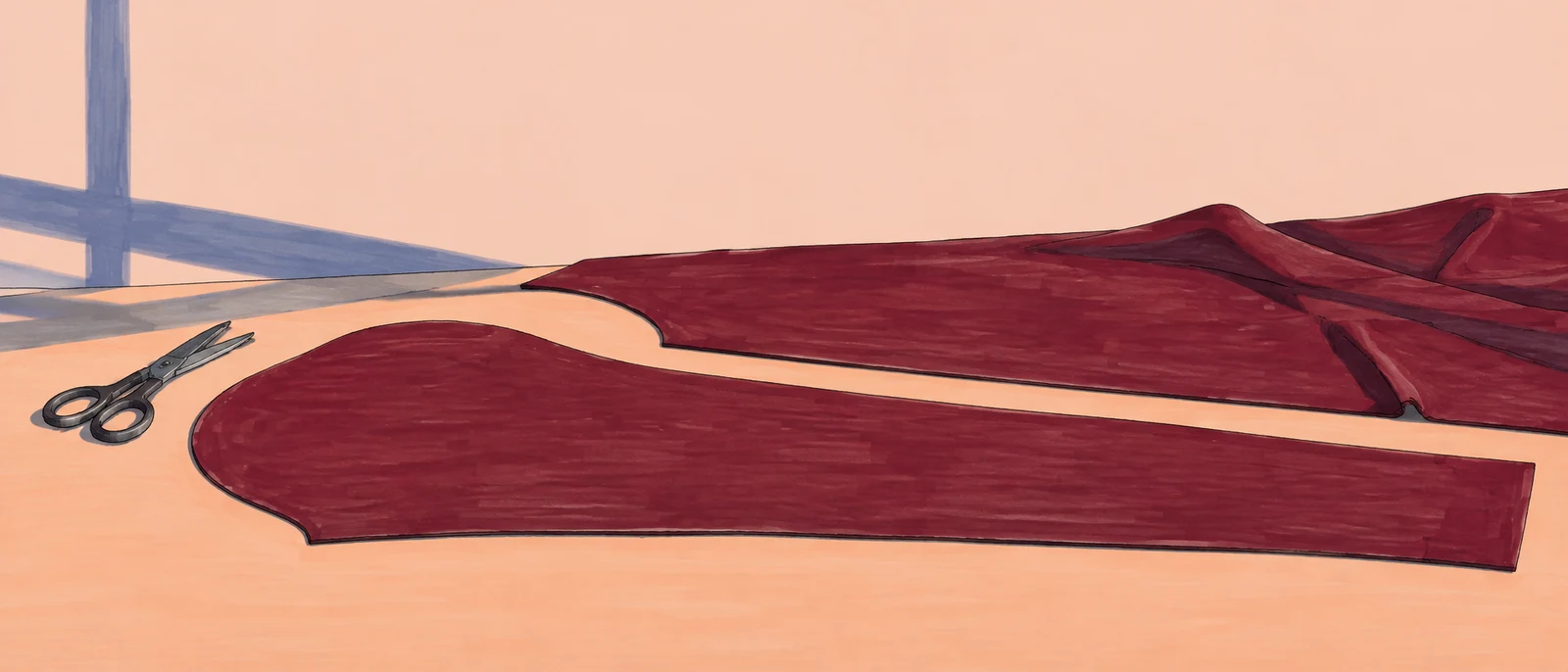 An elongated burgundy sleeve-shaped fabric piece lies across a pale peach cutting table, with matching fabric behind it and small tailoring shears at the left…