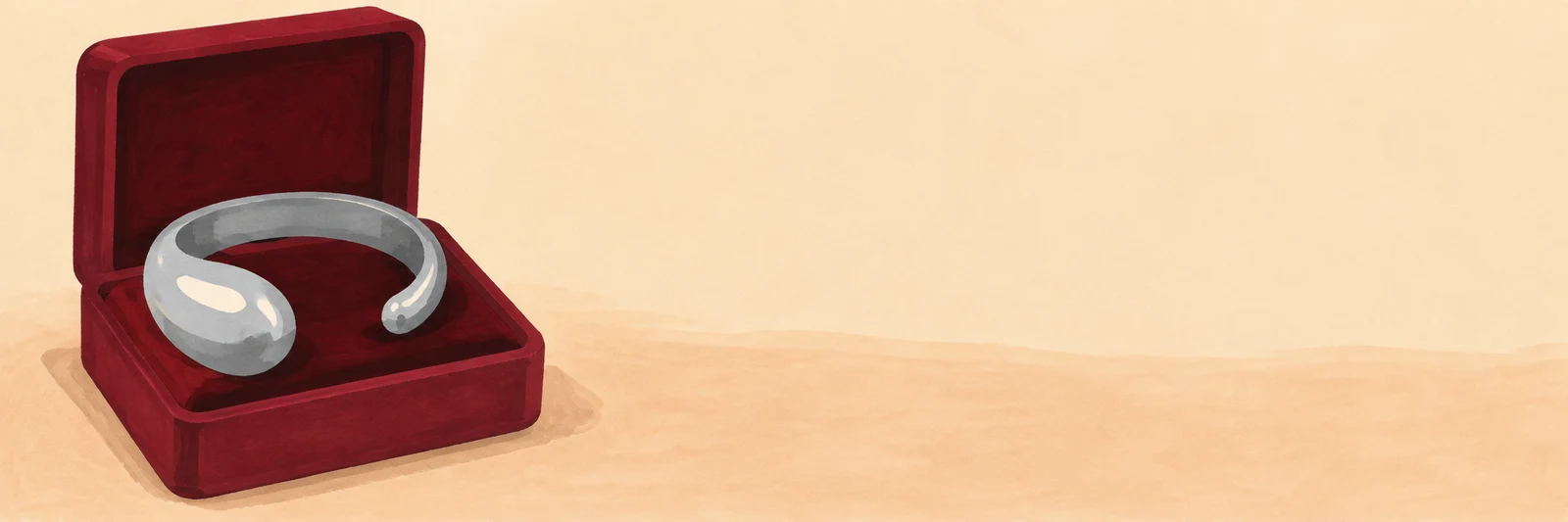 A chunky silver C-shaped cuff with one broad rounded end rests in an open burgundy jewellery box on a warm beige background, with ample empty space to the…