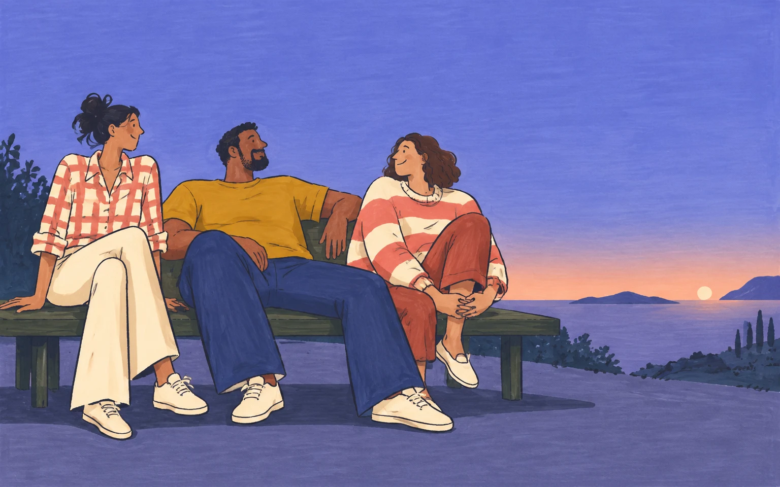 Three adults in patterned casual clothes sit together on a long green bench above a seaside view at sunset, with shrubs and distant hills along the horizon.