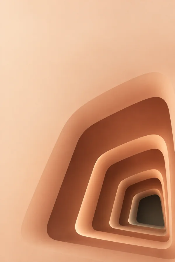A warm terracotta and peach optical tunnel of nested rounded trapezoidal openings recedes toward a small dark center in the lower-right of a pale apricot…