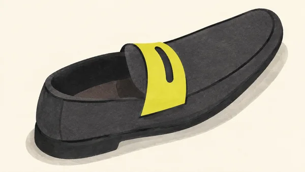 A charcoal penny loafer with an elongated rounded toe, open heel cavity, and bright acid-yellow strap with a dark slot, shown diagonally on a warm ivory…