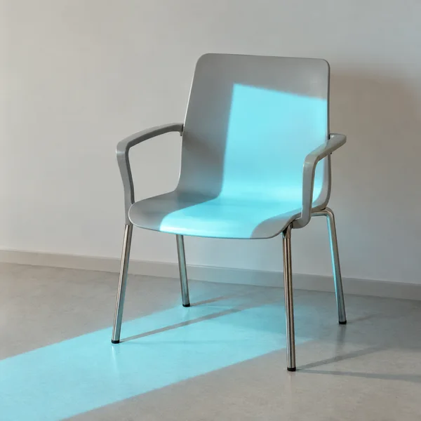 A pale-gray molded chair with armrests and slim stainless-steel legs stands against a warm-white wall on a pale floor, with a cyan rectangle of light falling…