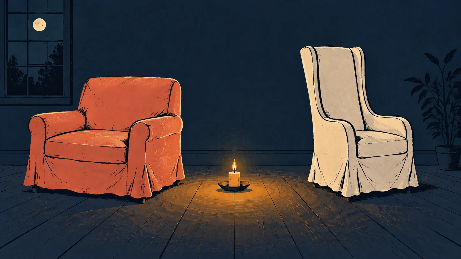 A coral slipcovered armchair and a tall cream armchair sit on a dark wooden floor with a lit candle in a saucer between them.