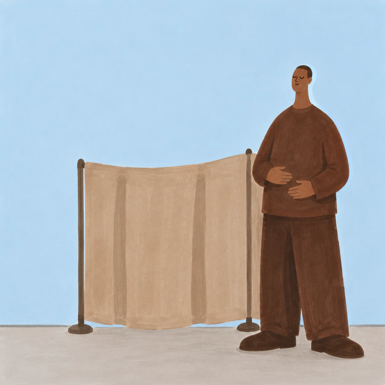 A person in loose dark-brown clothing stands with eyes closed and both hands on the abdomen beside a wide tan privacy screen, against a pale blue background…