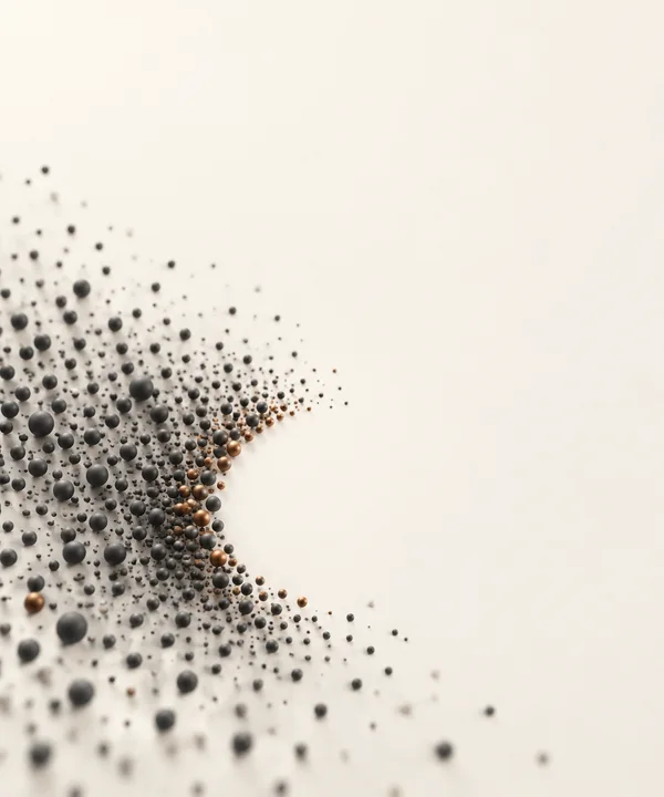 A field of charcoal and muted copper spheres spreads across the lower-left of a warm ivory background, with a curved open gap along its right edge and broad…