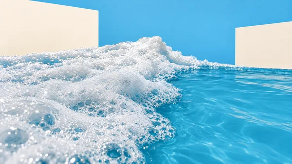 A close view of white sea foam sweeping diagonally across bright cyan water, with a blue background and two large cream rectangular shapes behind it.