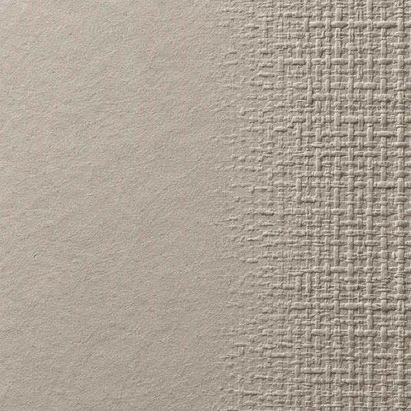 A warm-grey textured paper surface with a raised, irregular linen-like weave pattern along the right side, fading into mostly smooth paper across the left.