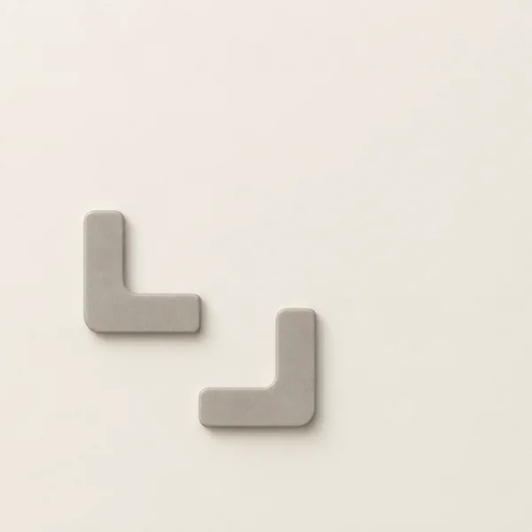 Two separate mushroom-grey elbow-shaped relief forms sit below and left of centre on a warm chalk background.