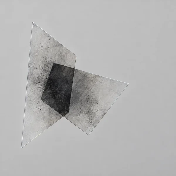 Two translucent, irregular angular planes overlap against a pale grey background, forming a dark charcoal polygon at their intersection.