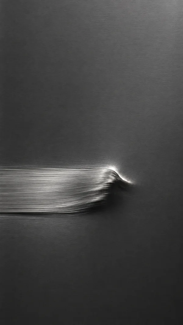 A vertical charcoal-gray metallic surface with a broad silver streak entering from the left below center and curling into a bright, dark-edged ridge just right…