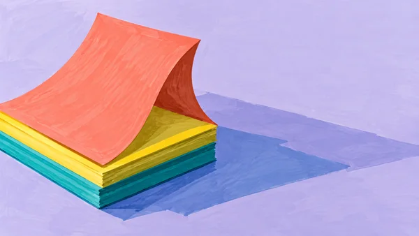 A stack of lemon-yellow and teal paper sits on a pale lavender desktop, topped by a broad coral sheet curling into an arch with a dark rust underside.