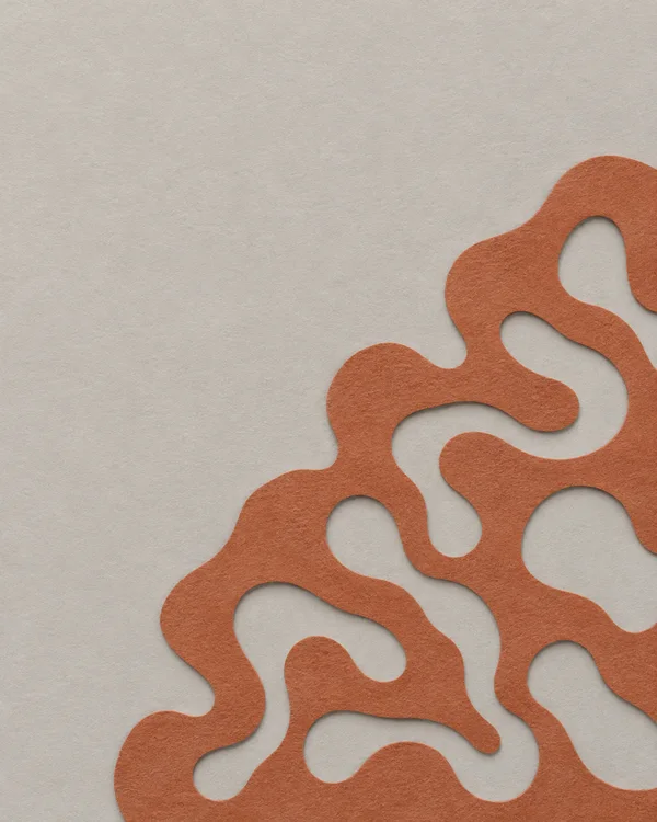 A terracotta paper form with broad, rounded winding openings lies over a warm-grey textured background, leaving open space above and to the left.