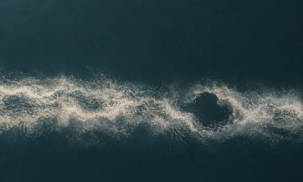 A pale, granular horizontal band of branching currents crosses a deep petrol-blue field, flowing around a dark irregular pocket to the right of center.
