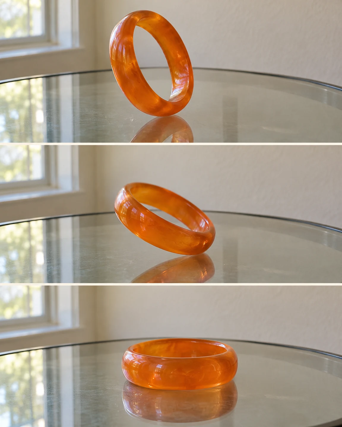 Three stacked views show a translucent orange bangle on a reflective glass table: nearly upright in the top frame, tilted low in the middle, and flat in the…