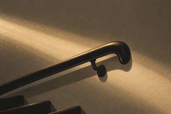 A near-black rounded stair handrail with a warm amber edge curves back near the right side and extends out through the lower-left edge.