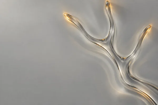 A transparent, branching glass form sweeps across the right side of a pale grey field, with three upward arms and warm amber highlights; the left side is…