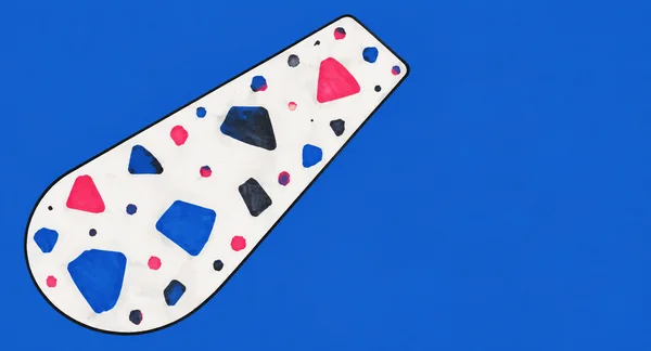 An elongated white terrazzo slab with a thick black outline lies diagonally across a cobalt-blue background.