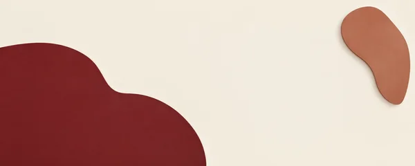 A large oxblood organic shape enters from the left and bottom edges of a warm ivory field, balanced by a smaller warm-clay shape near the upper right, with…