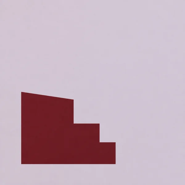 A large dark oxblood stepped polygon sits below and left of centre on a pale dusty-lilac square background, with broad empty space above and to the right.