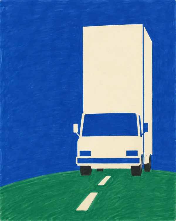 A tall ivory cab-over delivery truck faces forward on a green road, with a blue windshield and background, dark tyres, and two ivory lane dashes leading toward…