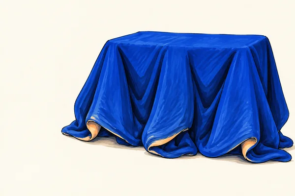 A large cobalt-blue cloth with a broad rectangular top drapes over a low concealed support, forming deep folds and pooling along the hem on an ivory background.