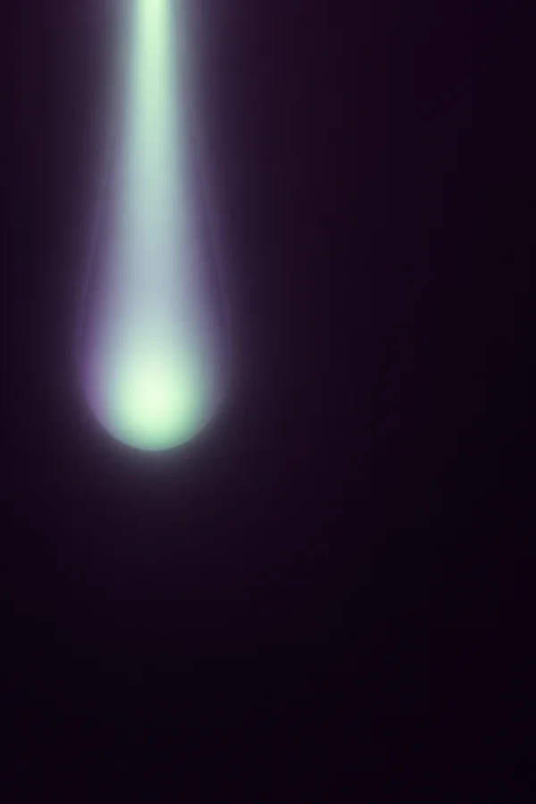A pale mint luminous band descends from the top near the left third, widening into a rounded green glow against a plum-black field, with smoky violet edges and…