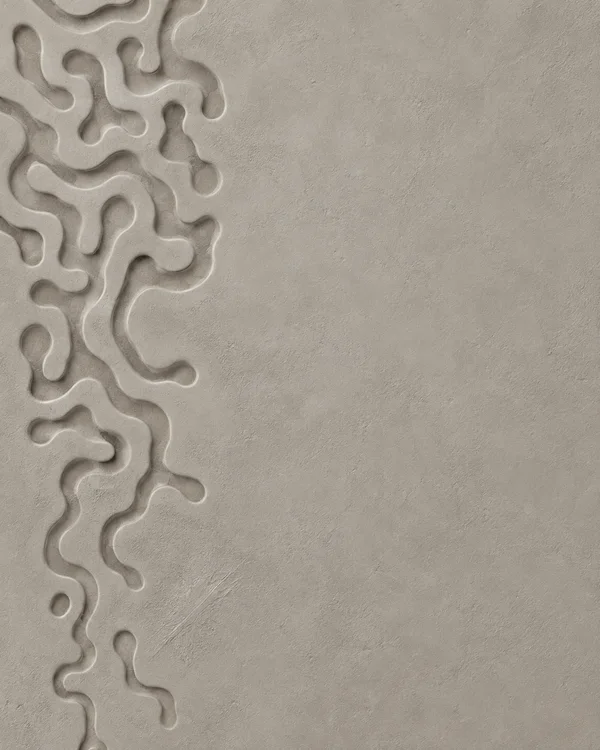 Warm-grey plaster relief with broad, winding recessed channels along the left edge and a largely open textured surface to the right.