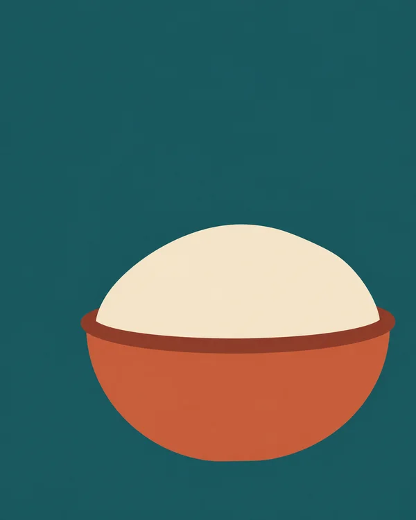 A broad terracotta mixing bowl with a dark-rust oval rim holds a large dome of pale ivory dough against a deep teal background.