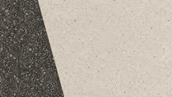 A two-field abstract texture with a densely speckled charcoal area on the left and a pale sand-colored grain field on the right, divided by a straight diagonal…