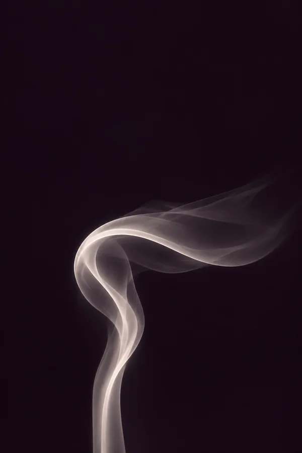 A translucent pearl-white smoke veil rises from the lower part of a deep plum background, curls into a rounded bend and drifts horizontally to the right…