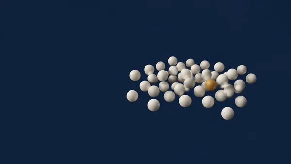 A loose cluster of ivory spheres with one amber sphere floats right of centre against a dark midnight-blue background, leaving broad empty space on the left.