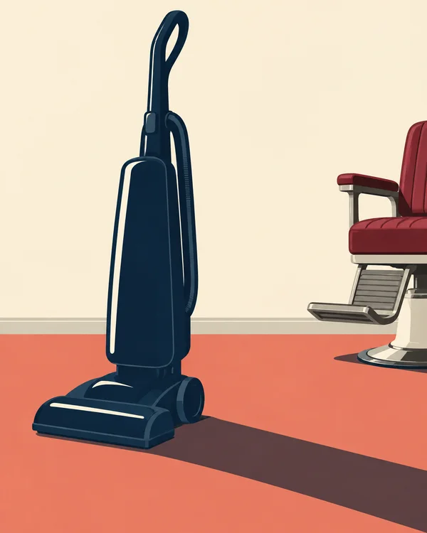 A dark navy upright vacuum stands on a coral floor against a warm ivory wall, with a long shadow stretching toward the lower right.