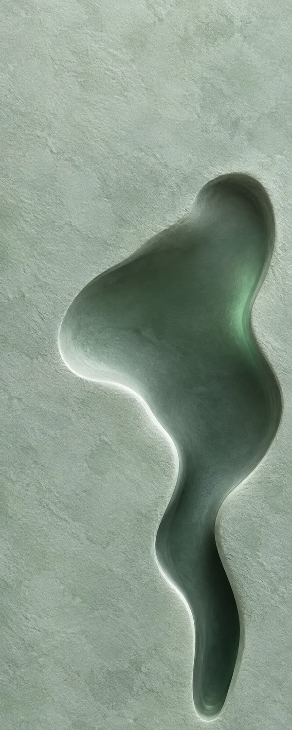 A pale celadon mineral-textured surface with a large, dark, irregular recessed form that widens into a softly lobed basin and narrows into a long channel; a…