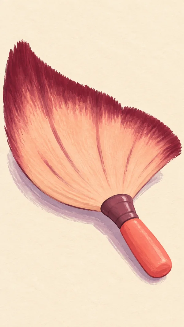 A large peach fan makeup brush with burgundy bristle tips, a plum ferrule and coral handle lies diagonally on a warm cream background, casting a lavender…