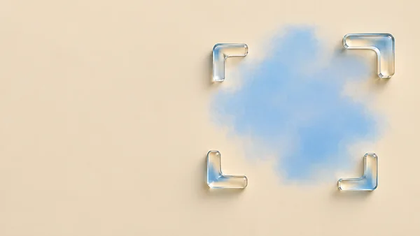 A diffuse sky-blue irregular patch sits right of centre on a pale sand field, loosely framed by four transparent glass L-shaped corners; the left side is…