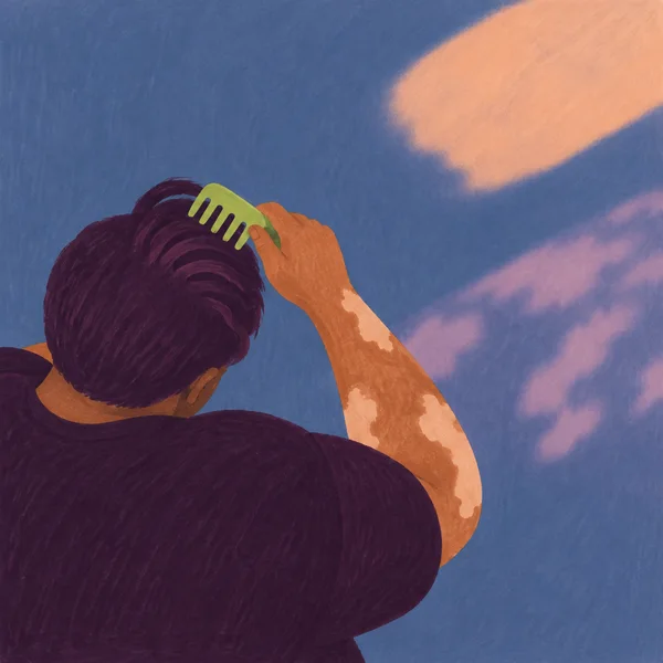 A person seen from above and behind combs thick aubergine hair with a lime-green comb.