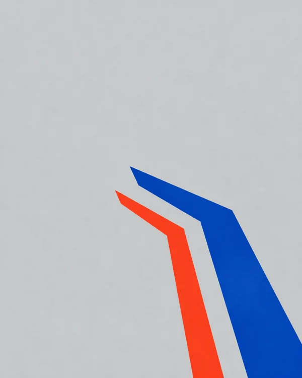 Two flat angular bands, one broad cobalt blue and one narrower vermilion, rise from the lower-right area and turn toward the upper-left across a pale cool-grey…