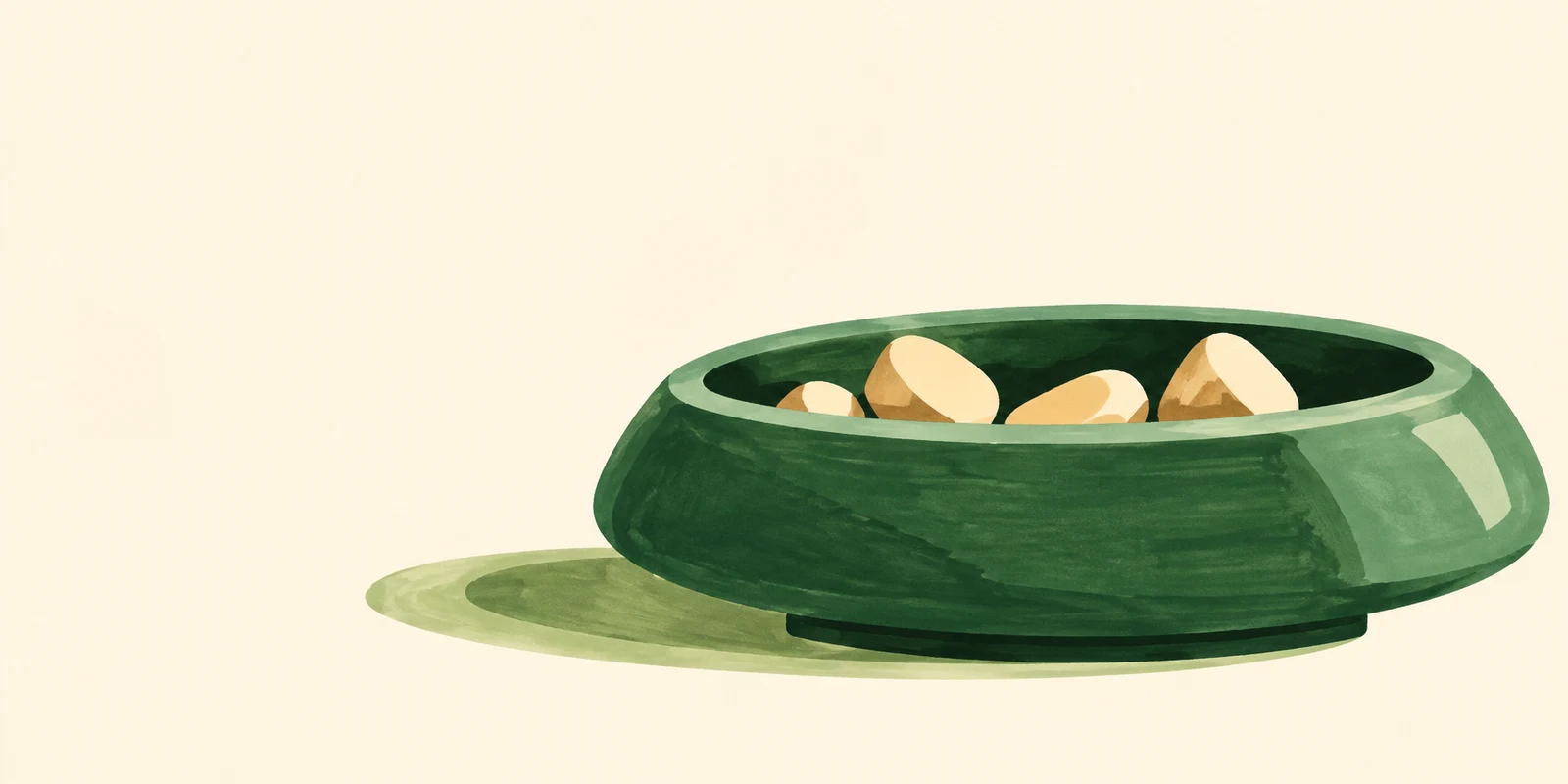 A broad forest-green pet bowl with a shallow body and small base sits on a warm cream ground, holding several oversized cream kibble pieces.