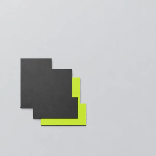 Two overlapping charcoal and acid-lime stepped paper shapes sit below and left of center on a pale gray background, with soft shadows and ample empty space.
