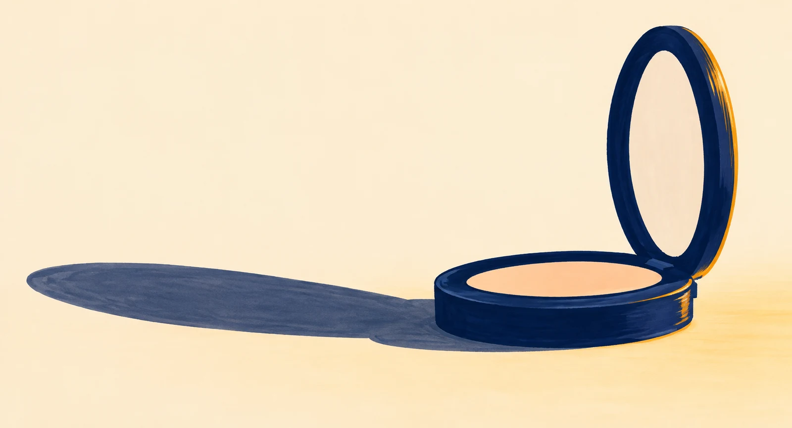 An open ink-blue cosmetic powder compact sits on a warm ivory surface, with a pale peach powder pan and a long dark shadow extending to the left.