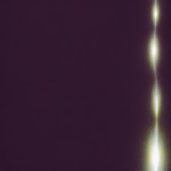 A square abstract artwork with a deep aubergine field and a slender vertical silver-white light leak near the right edge, separated into several glowing…