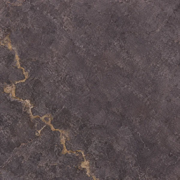A dark plum-grey stone surface with an irregular ochre vein entering from the upper-left edge and running down the left side toward the lower centre, amid fine…