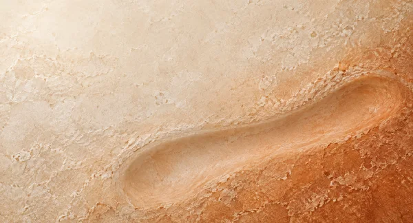 A landscape abstract mineral surface transitions from pale cream at the upper left to warm rust orange at the lower right, with a broad curved, smoother trough…