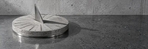 A low circular cast-concrete sundial with a brushed-steel triangular gnomon sits on a polished dark slab before a pale concrete wall, casting a shadow to the…